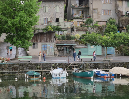People walking by Yvoire harbor