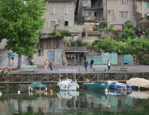 People walking by Yvoire harbor