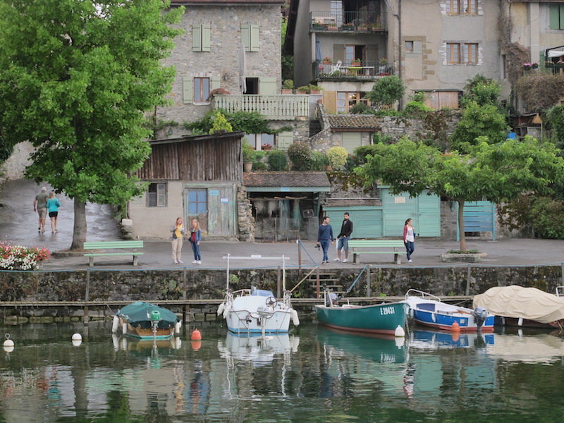 People walking by Yvoire harbor